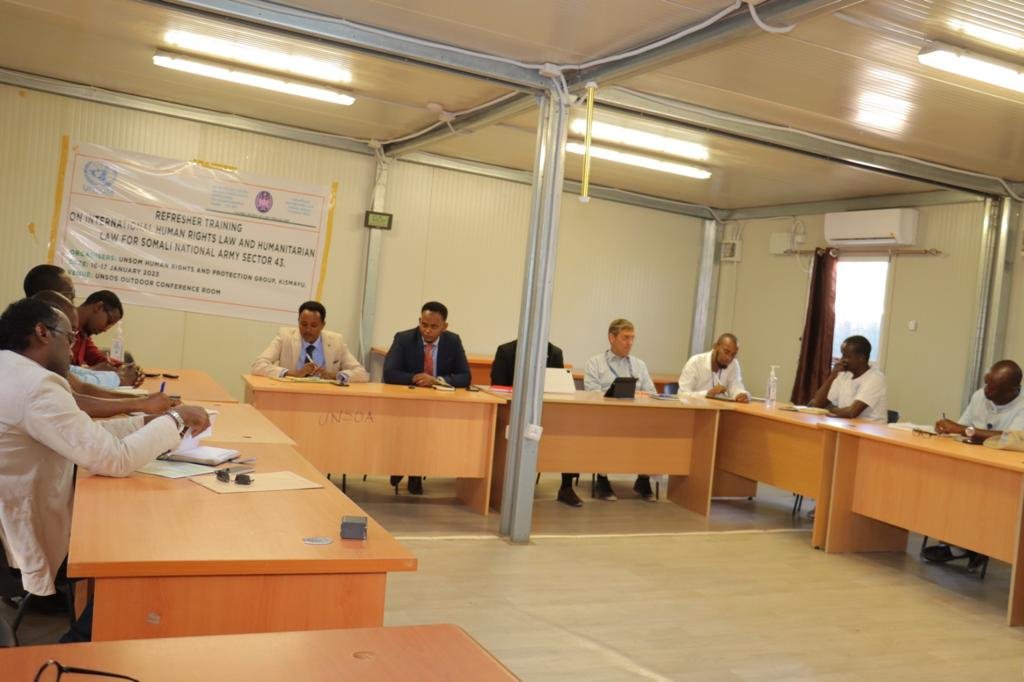 Facilitated meeting with participants seated around a conference table