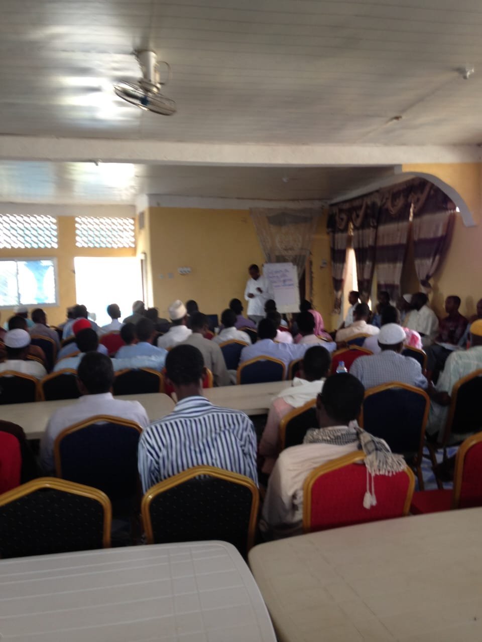 Facilitator speaking to participants in a learning session