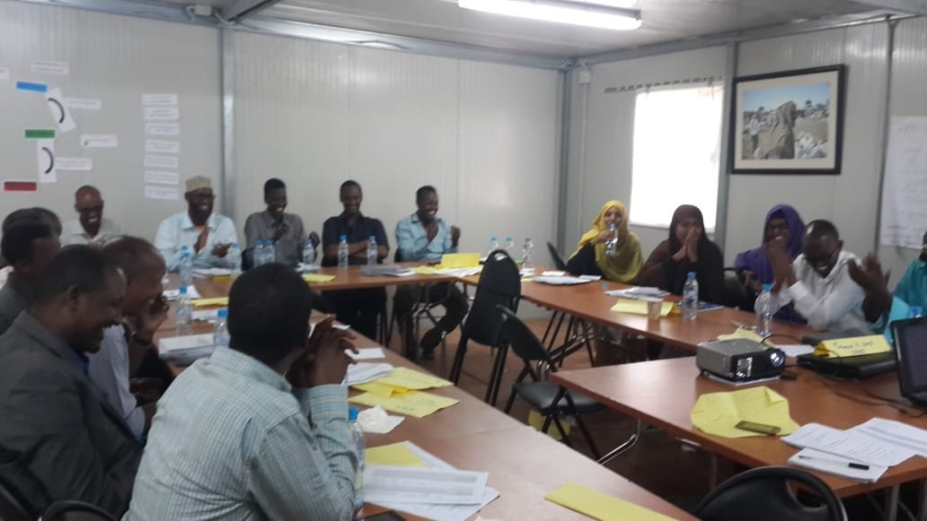 Workshop participants facing a presenter